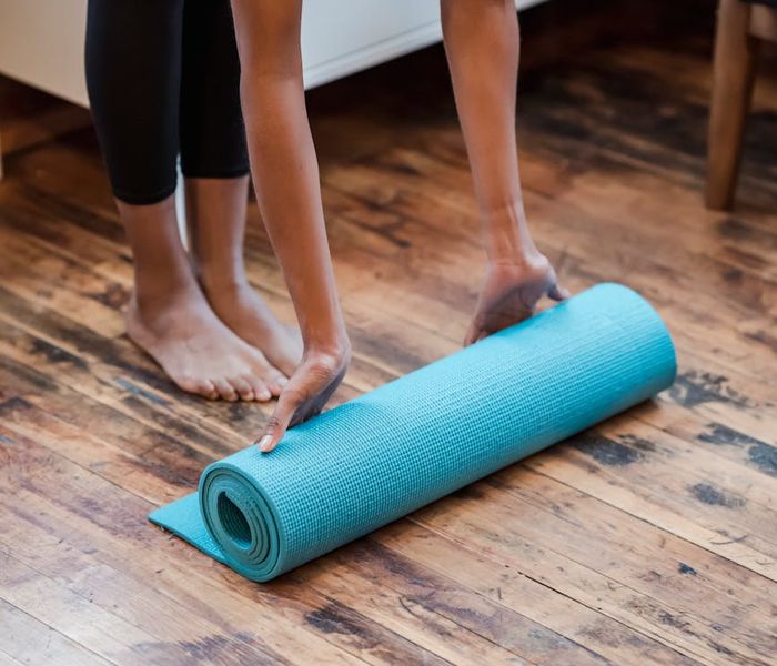 A spacious, bright room with a yoga mat on the floor, ready for practice.